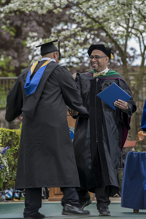 Several of the graduates were given their diplomas by their parents who are members of the Lycoming College community. Dr. Jeff Jeffries, a trustee on the college's board, gives his son his diploma.